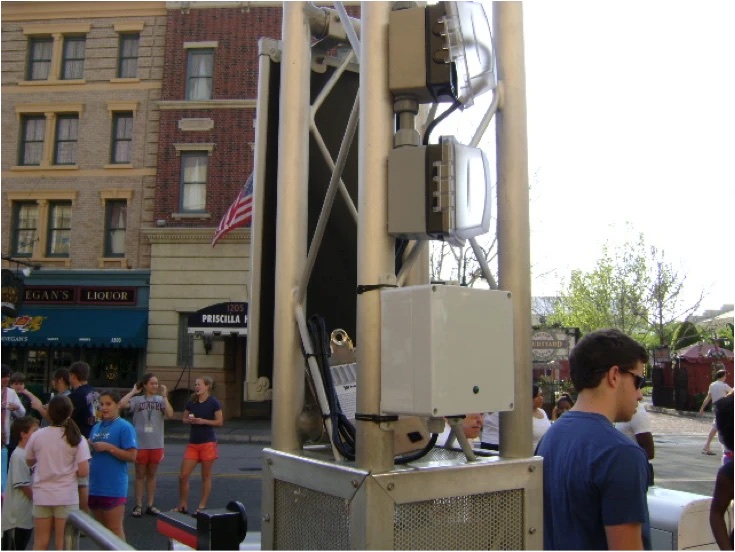 Ridelogix sensors mounted on a metal truss among guests on a street at Universal Orlando.